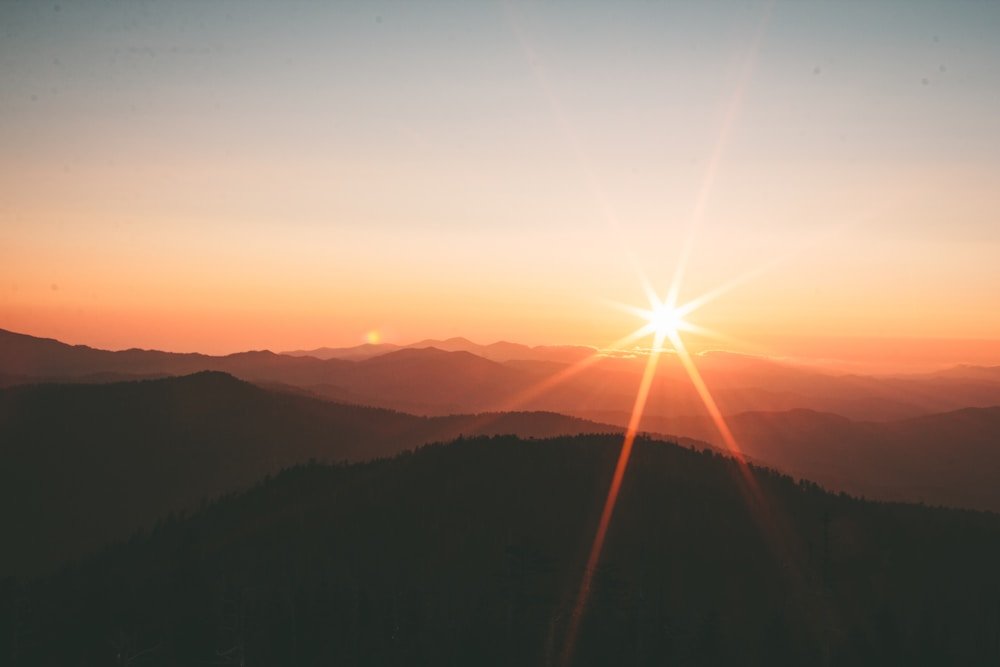 Sunrise over layered mountain ridges